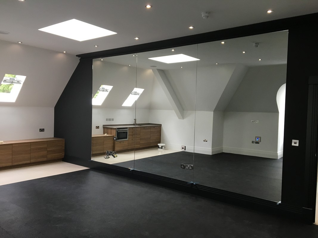 Frameless glass wall dividing loft conversion in Canning Town