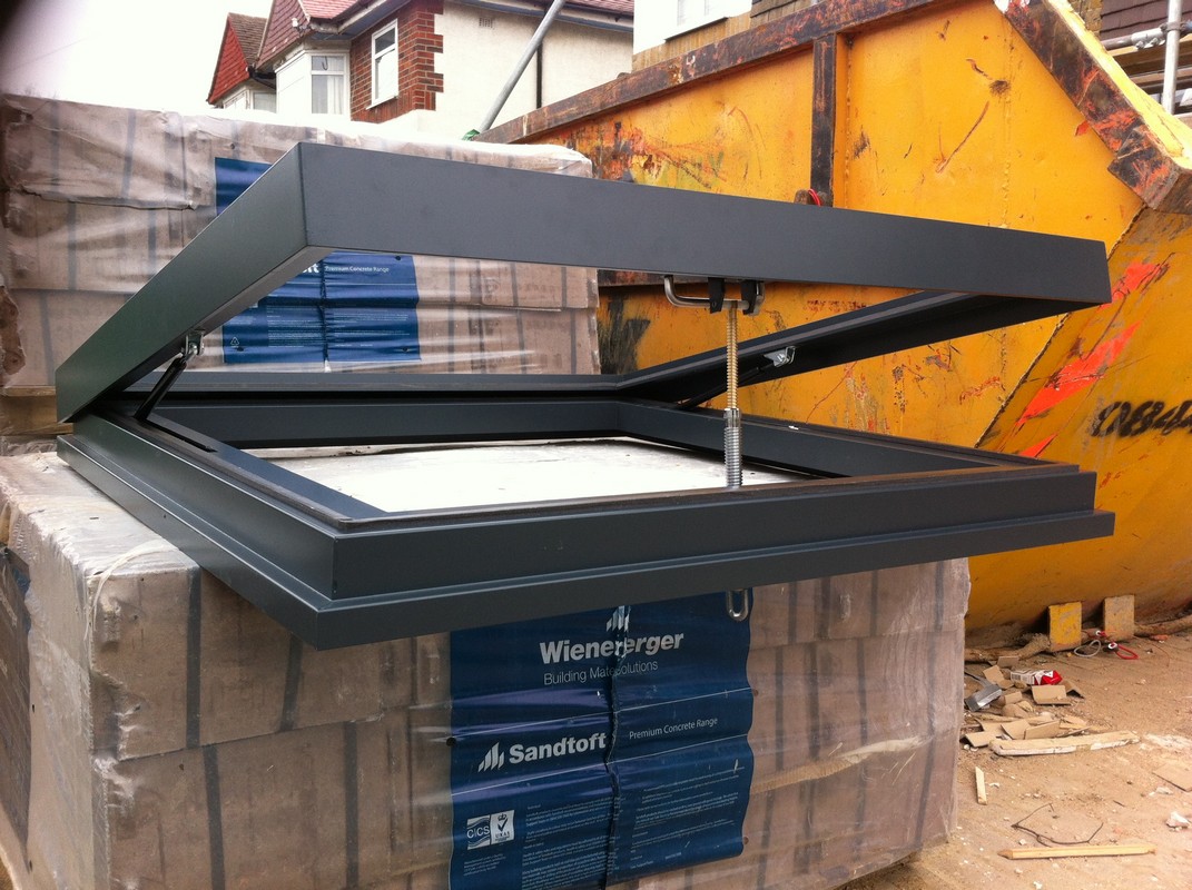 Opening flat roof skylight in anthracite grey installed in Canning Town